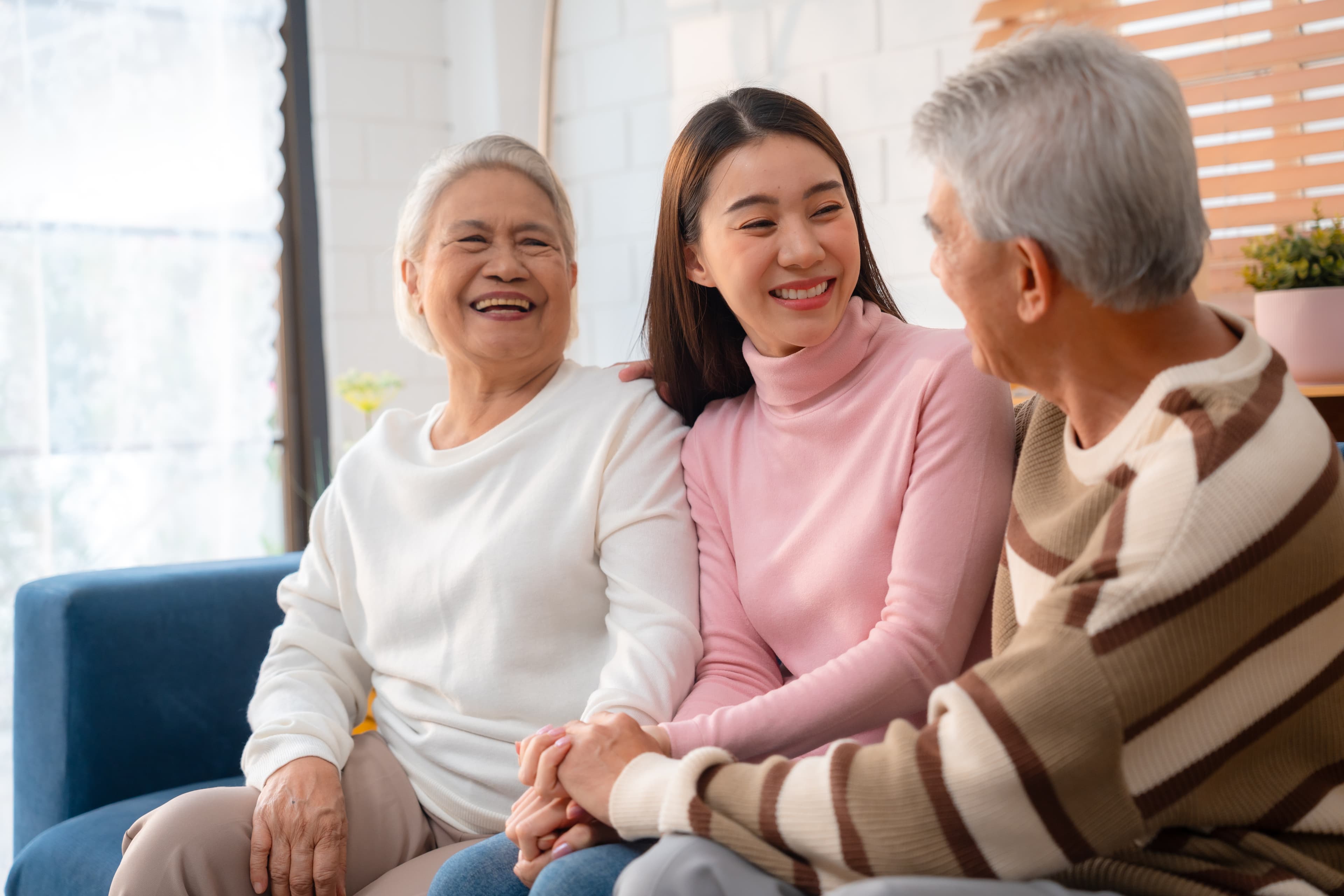 Happy family relaxing together at home with a senior relative