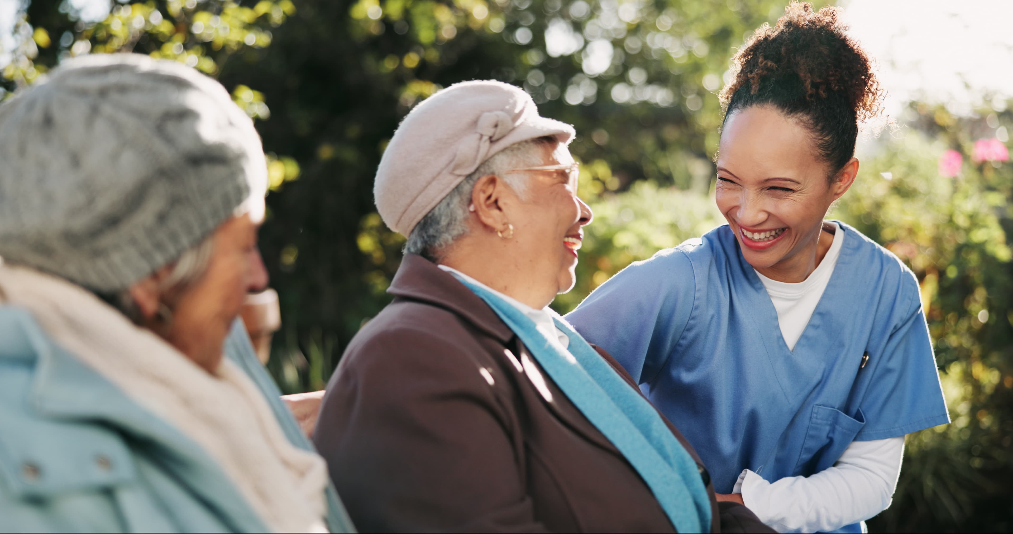 Senior couple laughing with a nurse